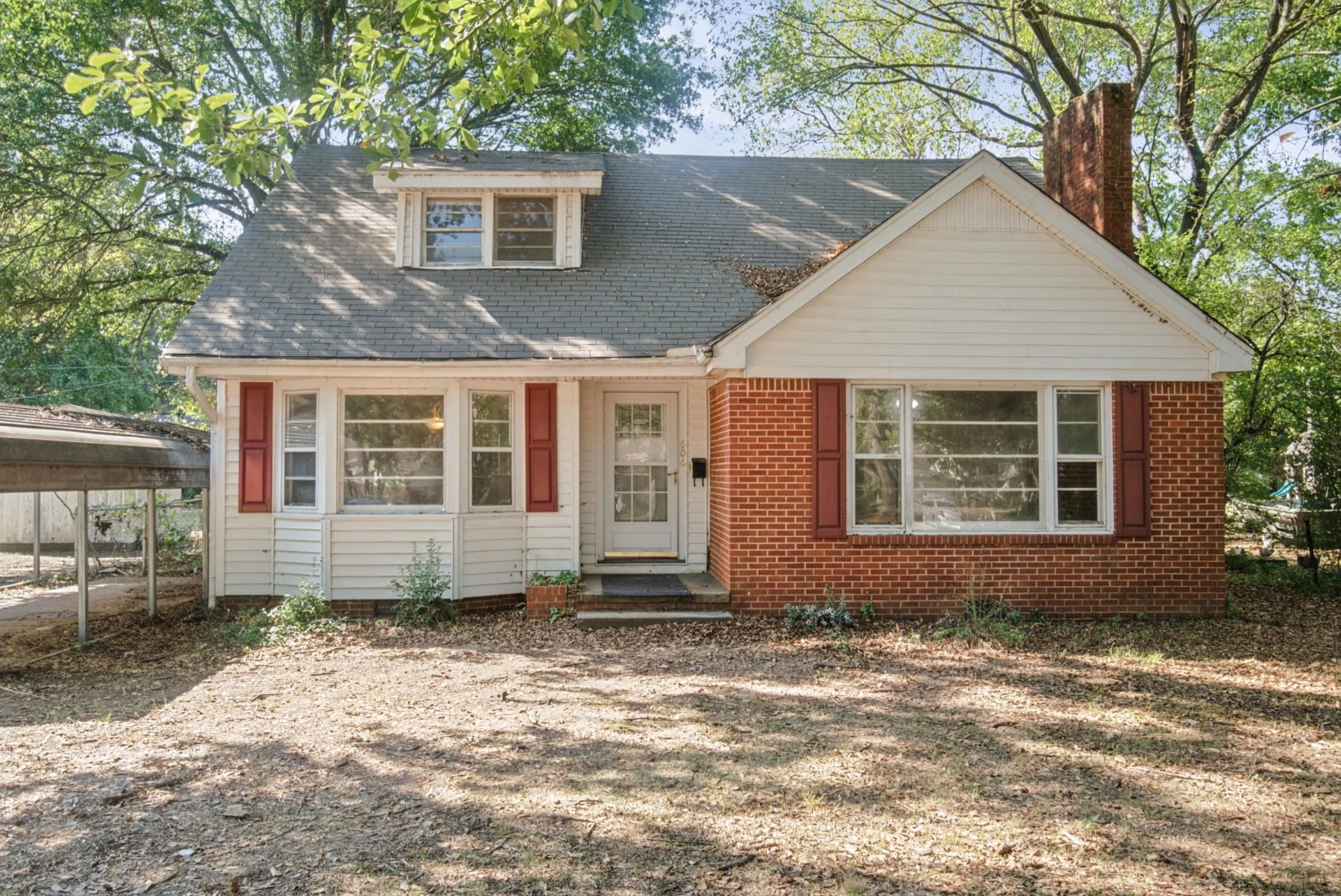 Newport Charmer home with brick front and red shutters